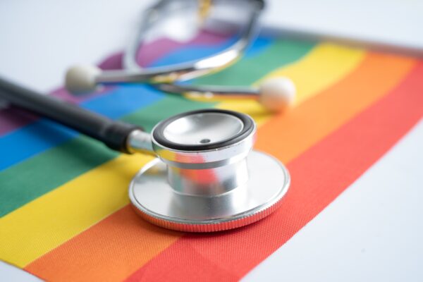 Black,Stethoscope,On,Rainbow,Flag,Background,,Symbol,Of,Lgbt,Pride
