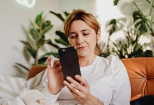 A patient accesses a mental health appointment on her smart phone